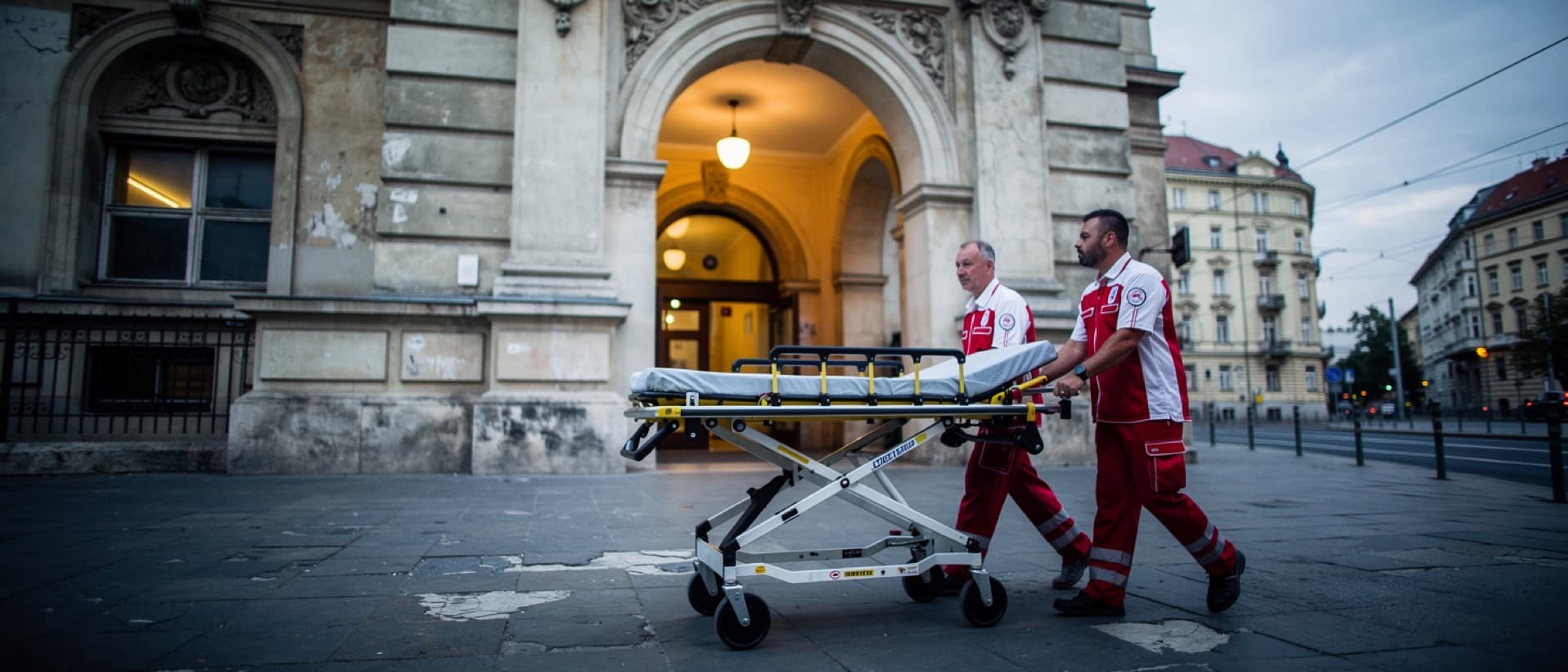 Paramedics wheeling a stretcher into an old Budapest hospital, for treatable versus preventable deaths compared across Europe