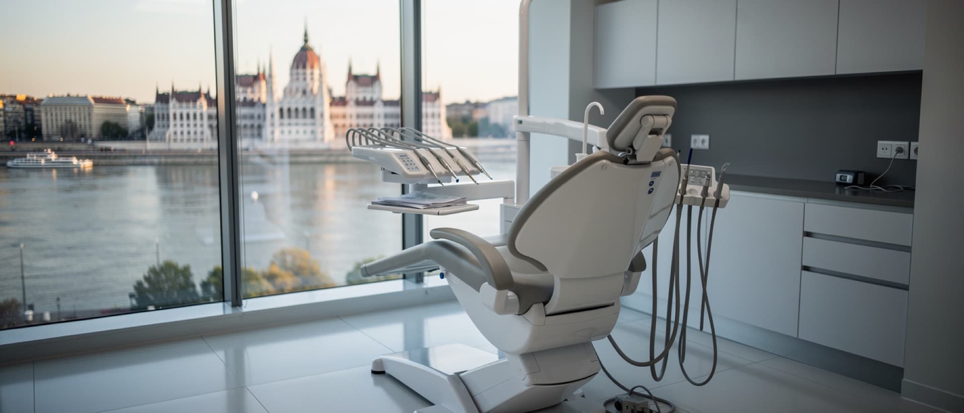 Dental chair by a window overlooking the Danube and Budapest Parliament, for Budapest dental implants cost