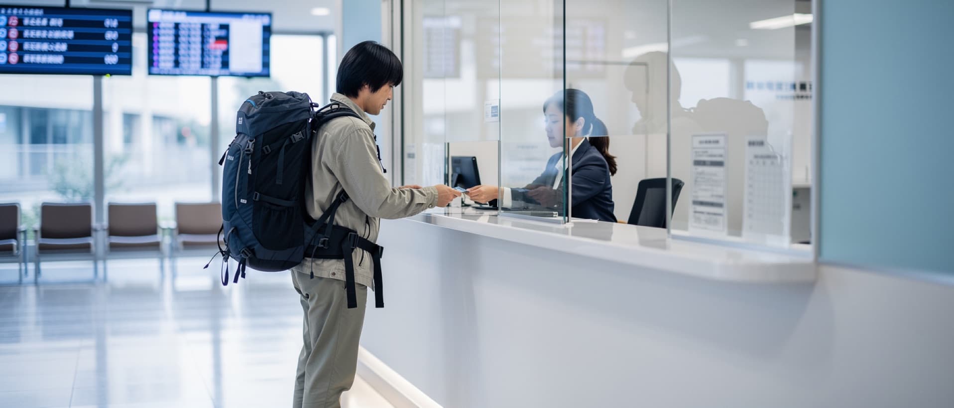 Tourist paying at a Tokyo hospital cashier window, for what a Tokyo doctor visit costs tourists