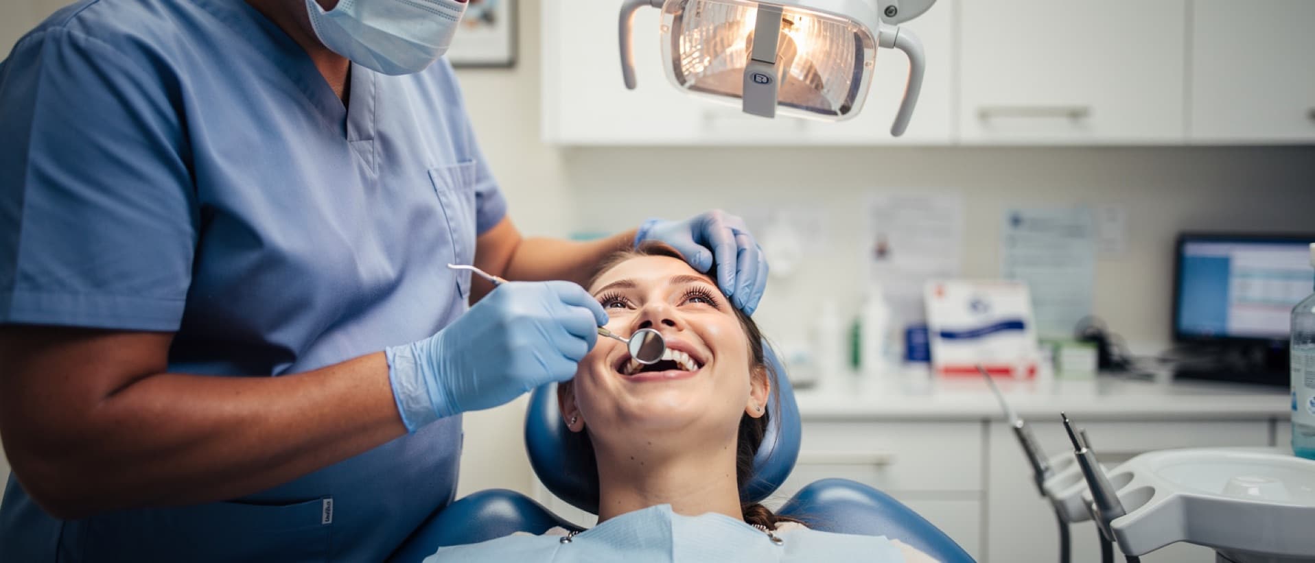 Dentist checking a patient's white veneers with a mirror, for the Turkey teeth corrective treatment claim